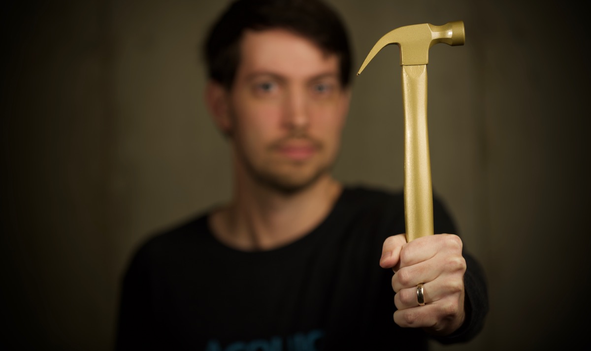 Jeff Geerling holding a golden hammer