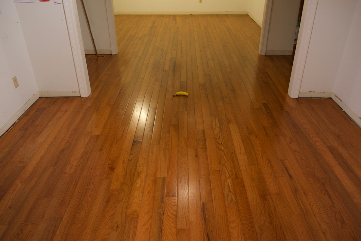 Flooring project completion of wood laying with banana for scale