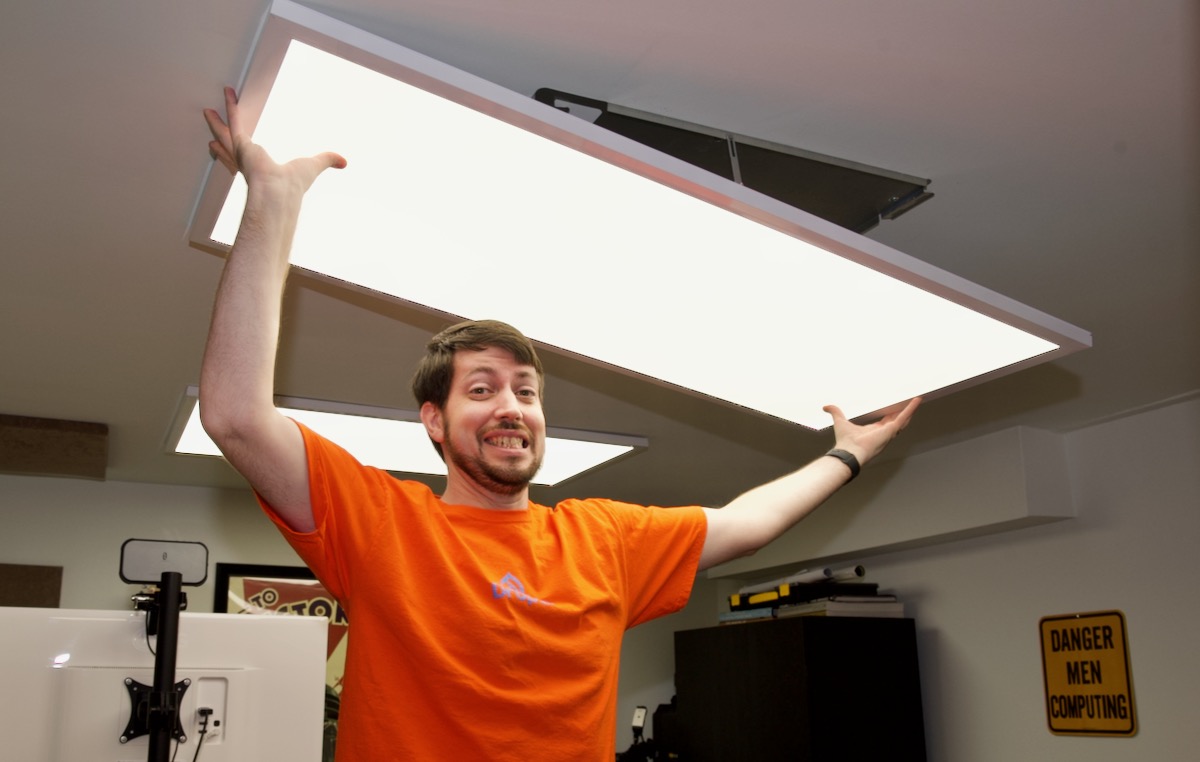 Jeff holding overhead light in office