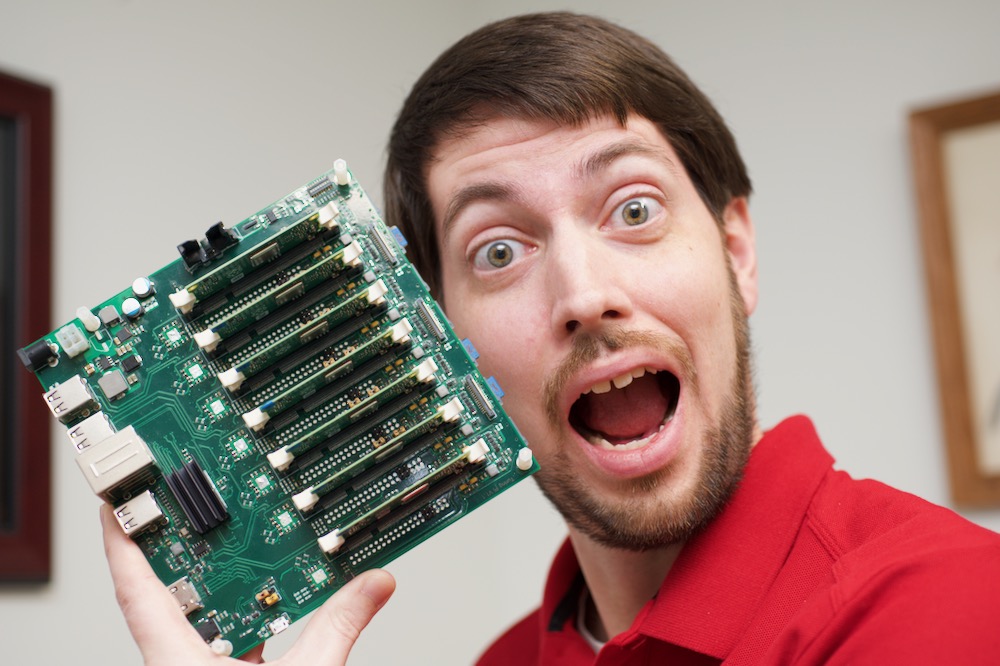 Jeff Geerling acts surprised for a YouTube thumbnail pic, while holding a Turing Pi