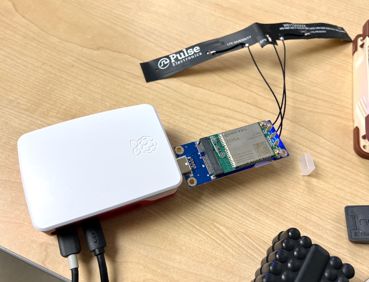 Raspberry Pi 4 with 4G LTE modem and antenna on desk