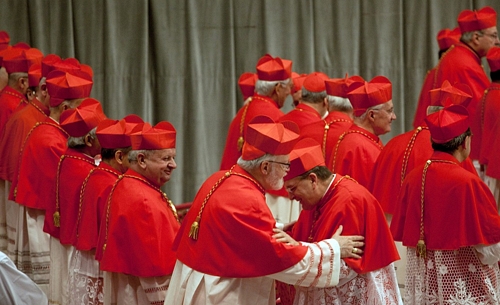 Cardinal Burke gives the sign of peace to Cardinal O'Malley