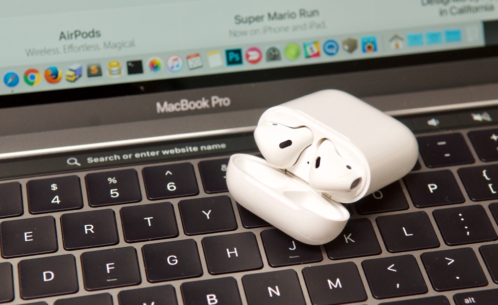 AirPods on 2016 MacBook Pro 13" Touch Bar Safari address bar in Charging Case
