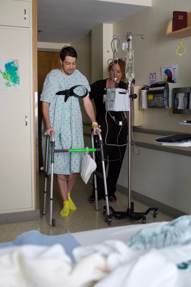 PT walking with lift strap and walker post-op