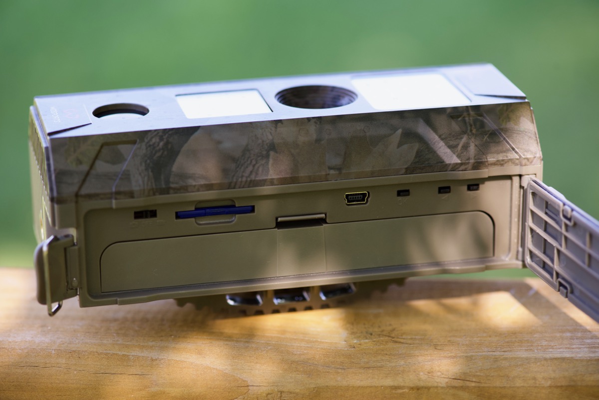 Wosports Trail Camera - controls, SD card slot, and battery pack on side