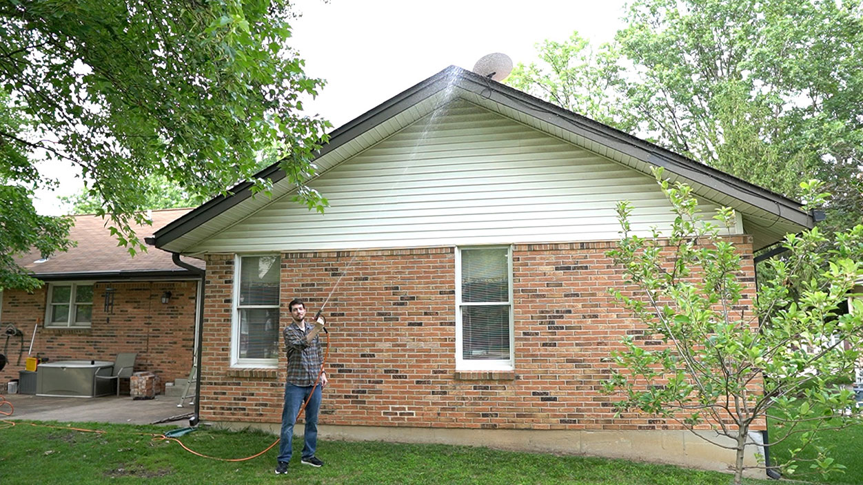 Jeff Geerling waters Dishy on roof - Starlink Satellite Internet