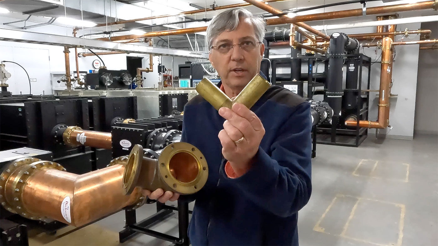 Dad holding 90-degree coax hard line connection elbow