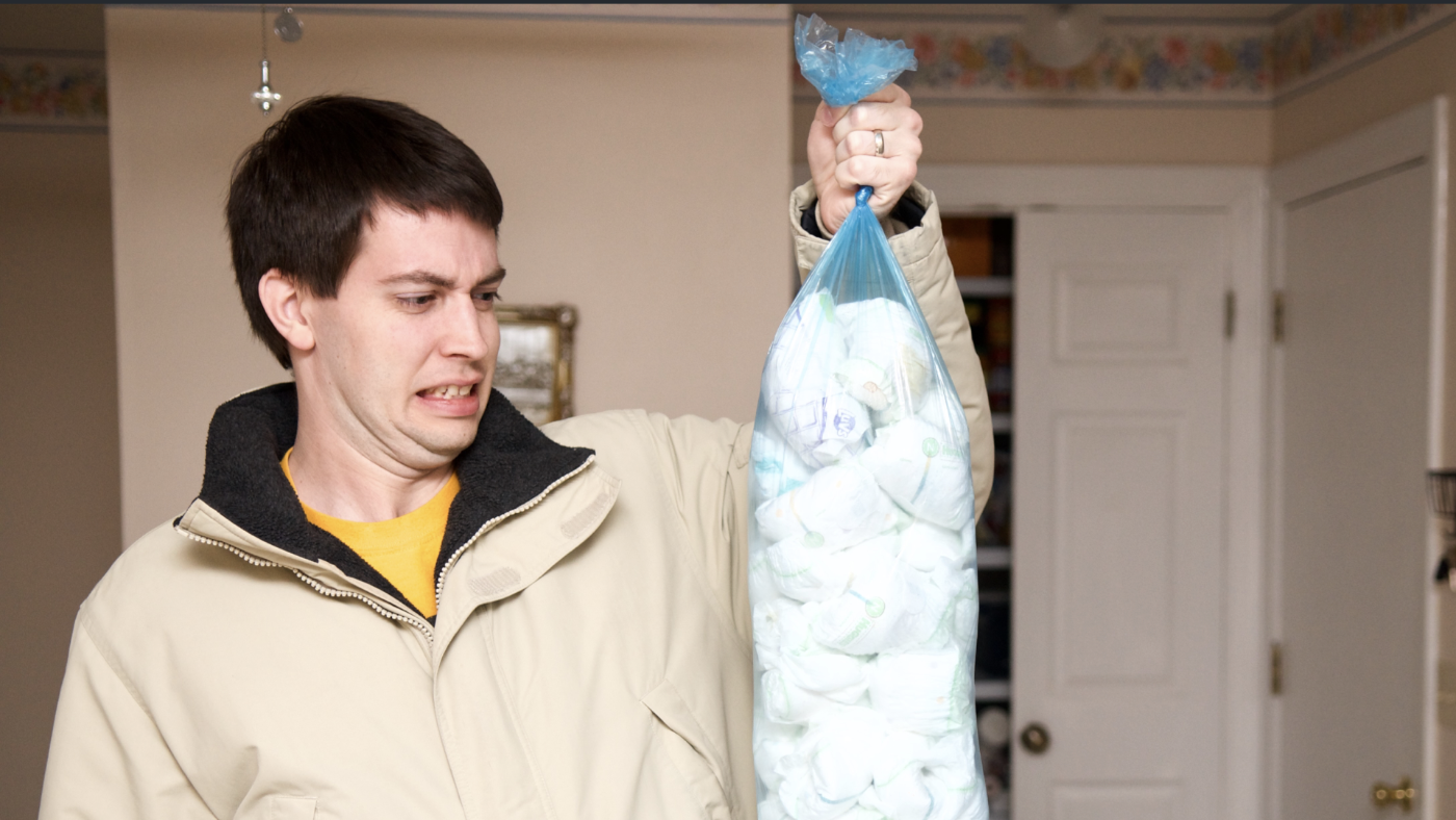 Jeff holding bag of diapers