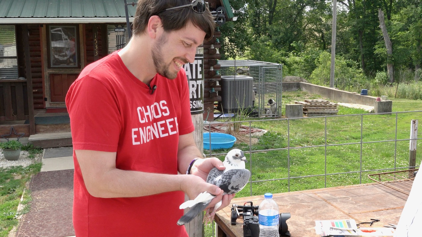 Jeff Geerling holding a homing pigeon