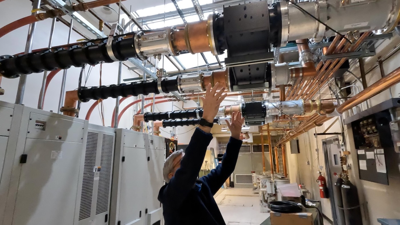 Dad showing the transmitter feed lines and coax combiners