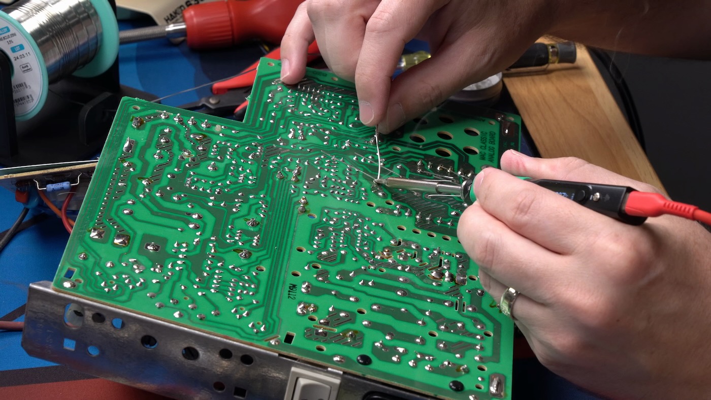 Recapping Macintosh Classic analog board soldering underside with pinecil