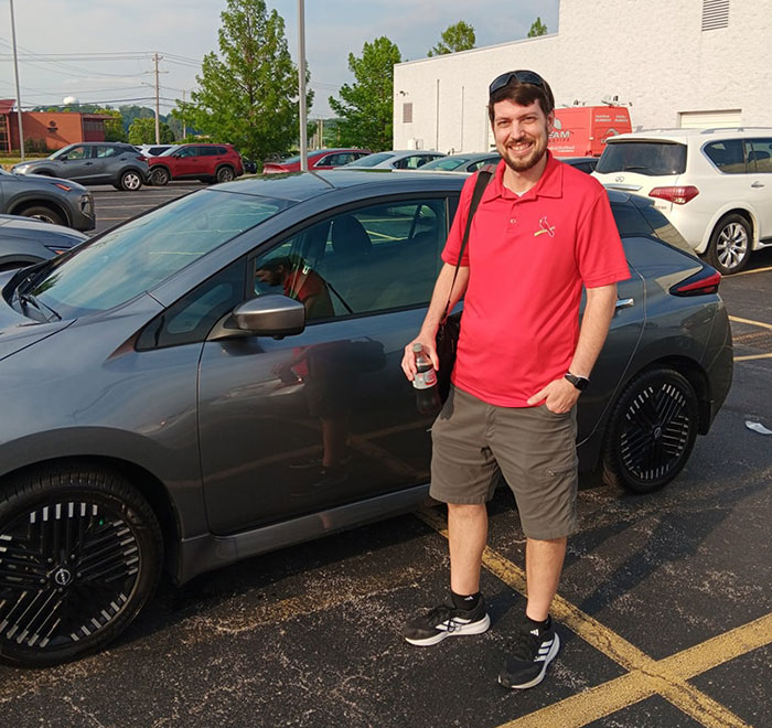 Jeff Geerling with Nissan Leaf SV Plus at Dealership