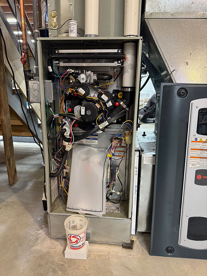 Silicone mat draining water away from control PCB in Trane S9V2 furnace