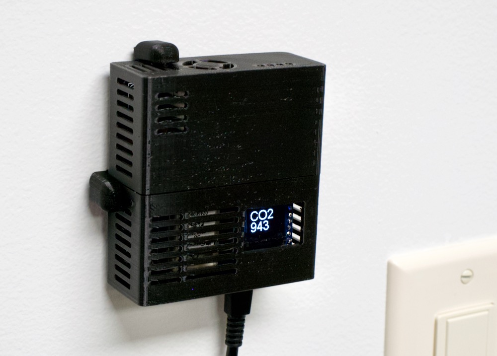 AirGradient DIY air quality monitor mounted on wall inside 3D Printed case