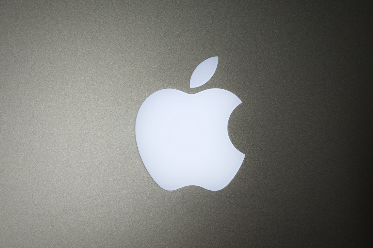 Apple logo on glowy laptop background