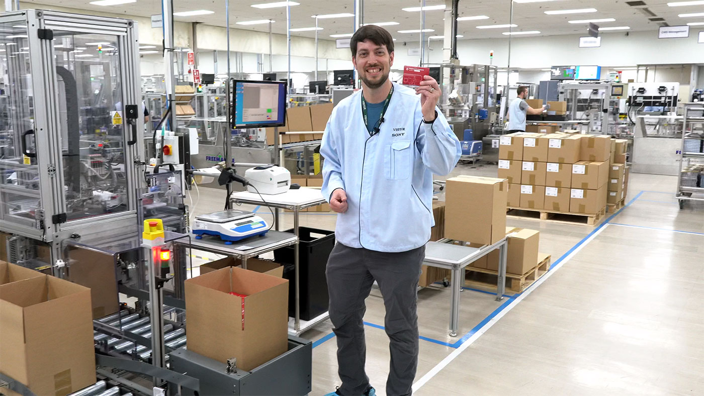 Jeff Geerling holds a Raspberry Pi on the production line at Sony UK