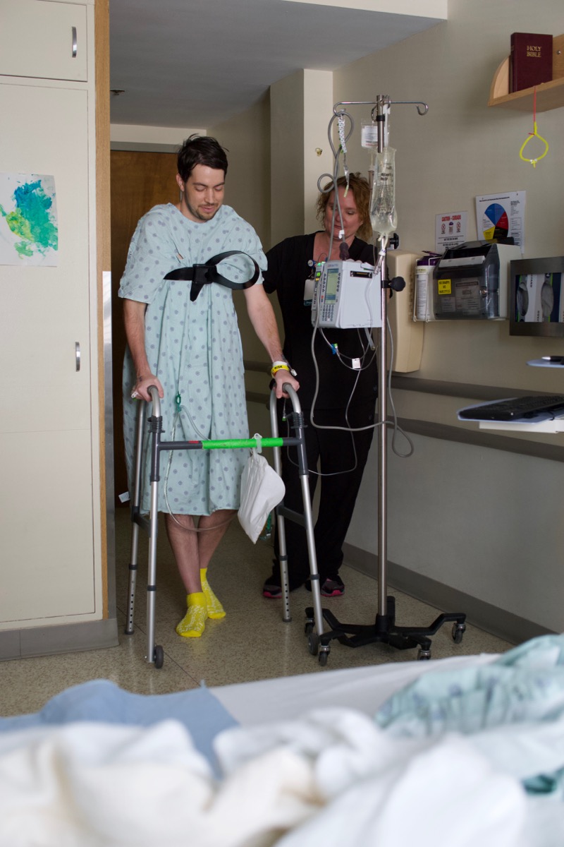 PT walking with lift strap and walker post-op